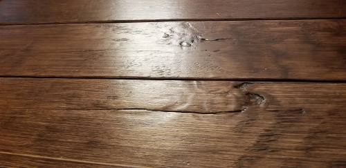 DIY Rustic Wide Plank Flooring Made From Plywood - a closeup of the distressing