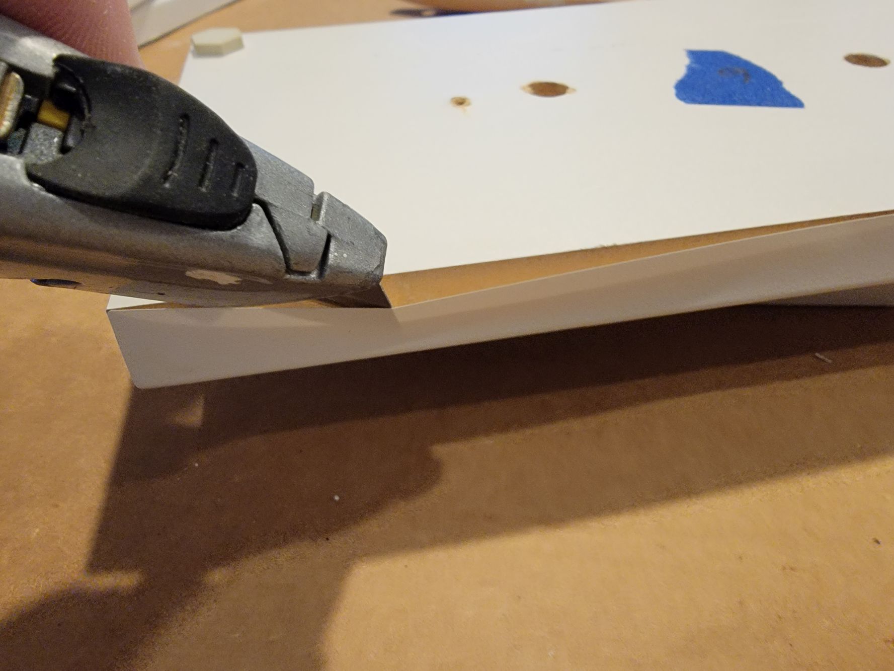 How to Paint Laminate Cabinets - Use a Utility Knife to Separate the Plastic From The Door Then Twist